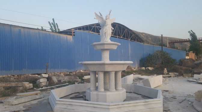 large marble water fountain with angel statues