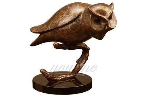 owl statue standing on the tree