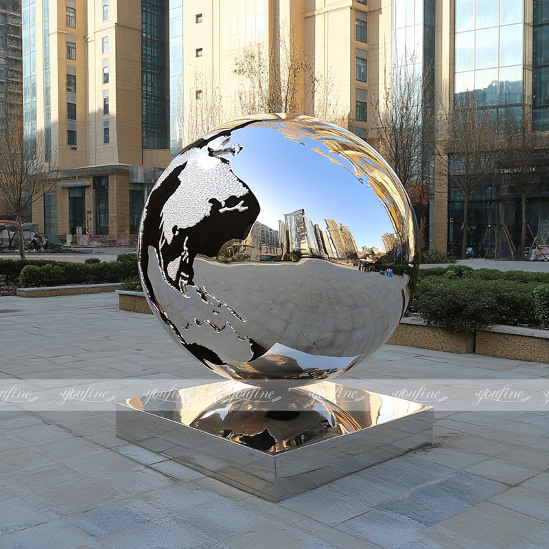 modern metal polished globe sculpture