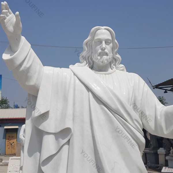 Outside huge catholic white marble church statues of christ Jesus making for parish garden