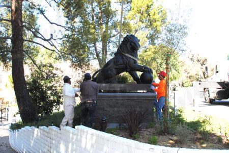 Outdoor bronze casting lion statues with ball in front of the zoo made for client from USA