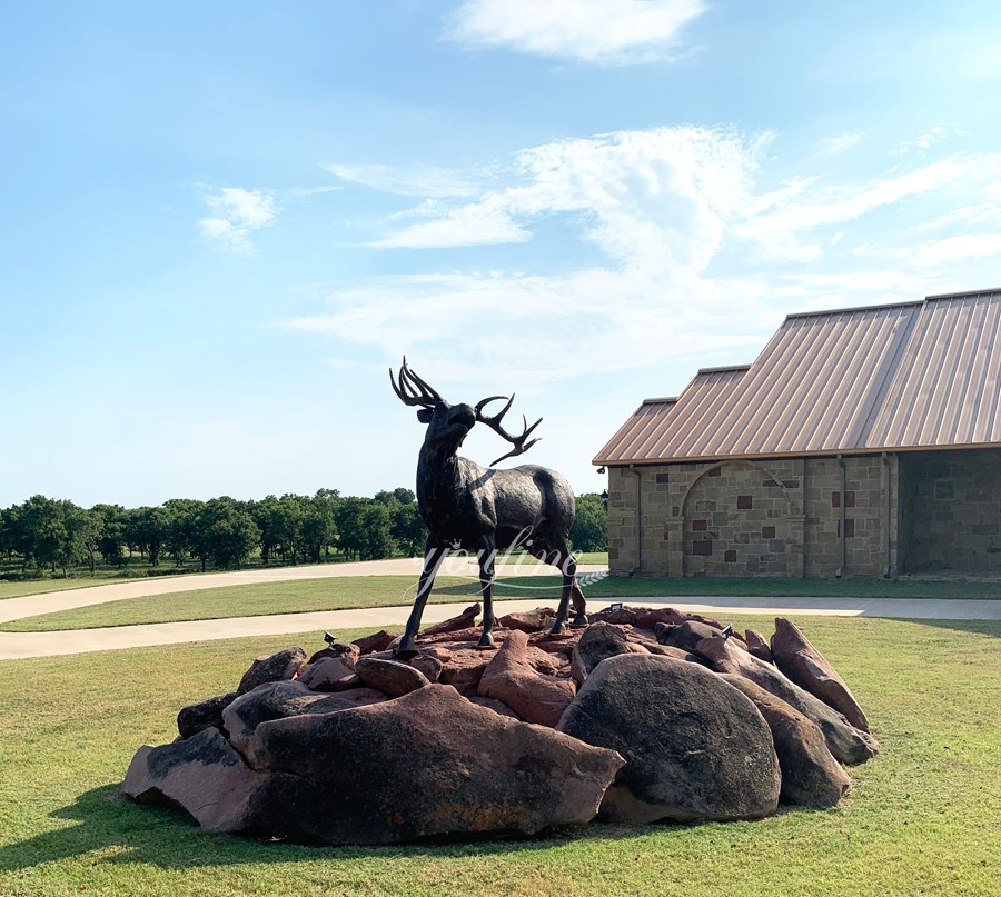 large elk bronze statue in village