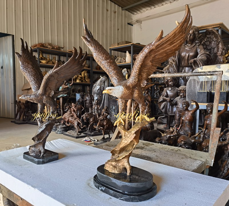 two Eagle sculptures standing on the tree stump