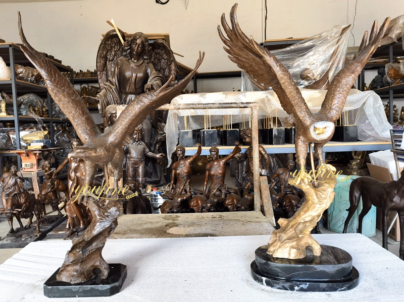 two Eagle statues standing on a tree stump