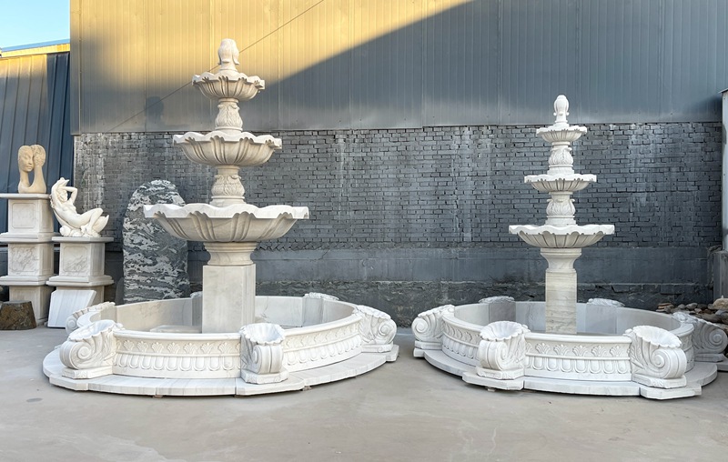 Tiered white marble fountain