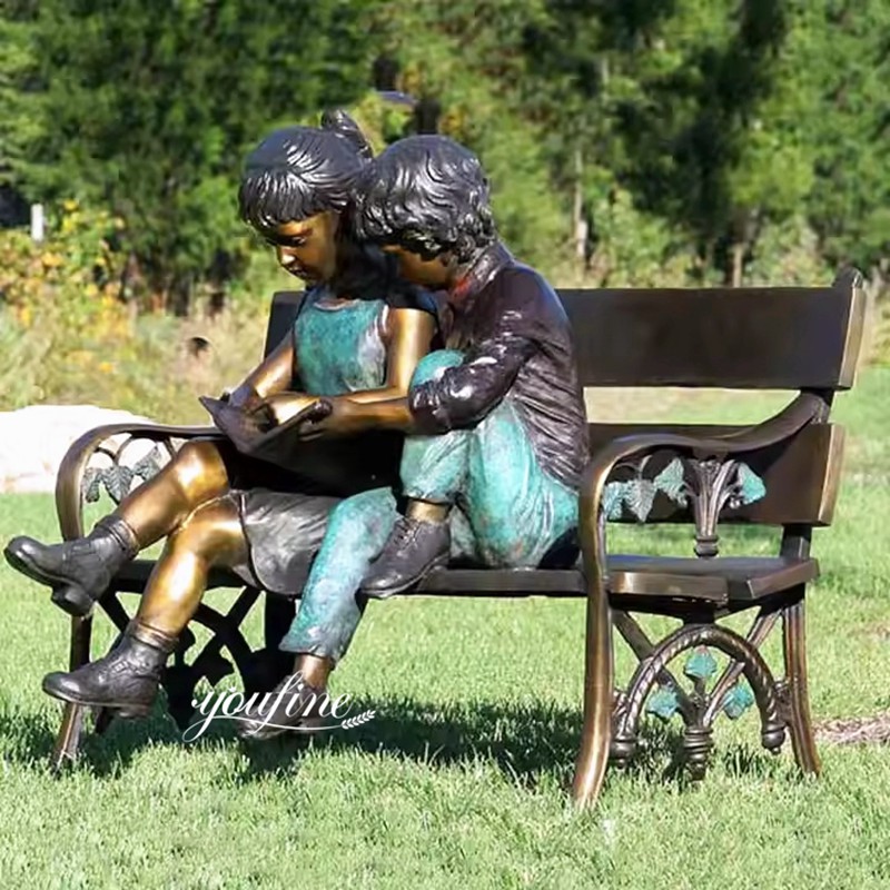 boy and girl reading garden statue