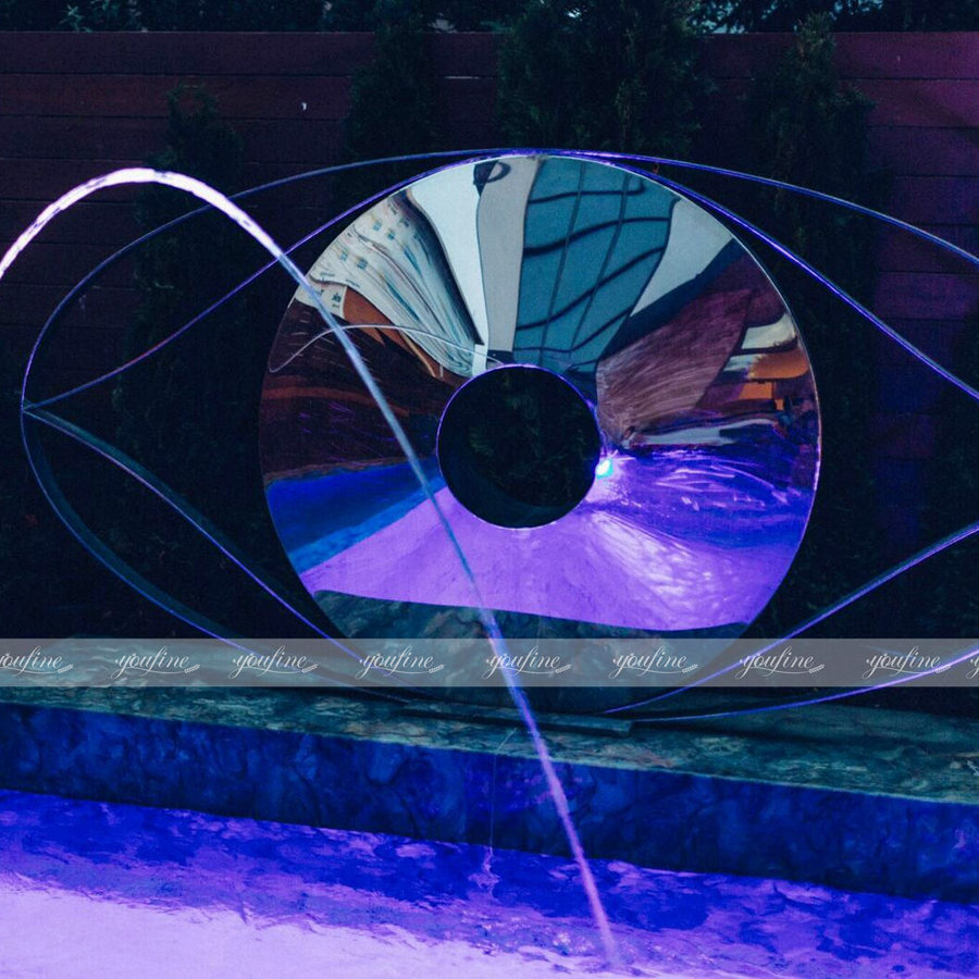 metal disc sculpture for swimming pool decor at night