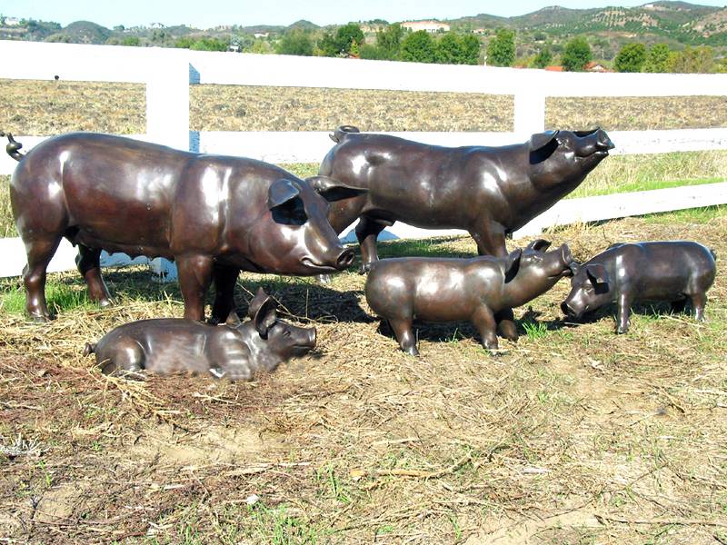 Realistic pig statues for farm-themed displays