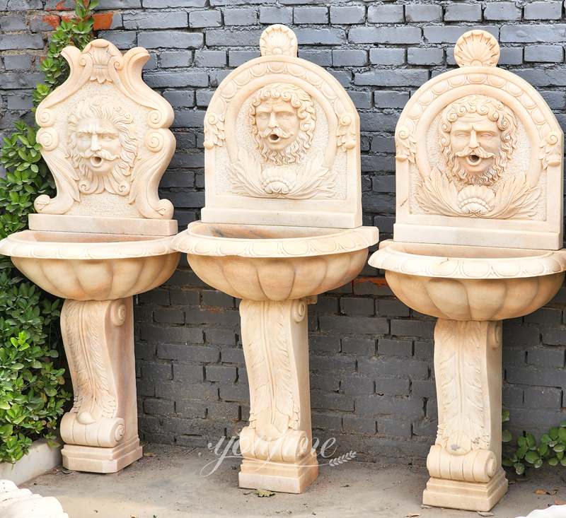 Lion head sculptures marble wall fountain