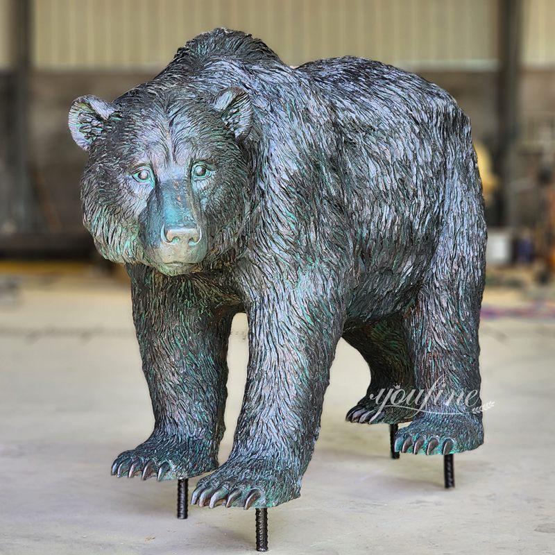 copper-green walking bear sculpture