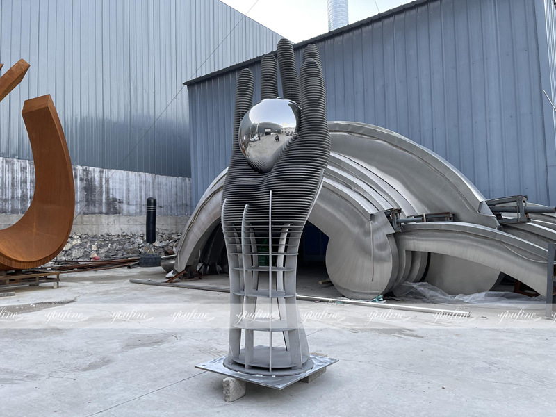 large stainless steel hand sculpture