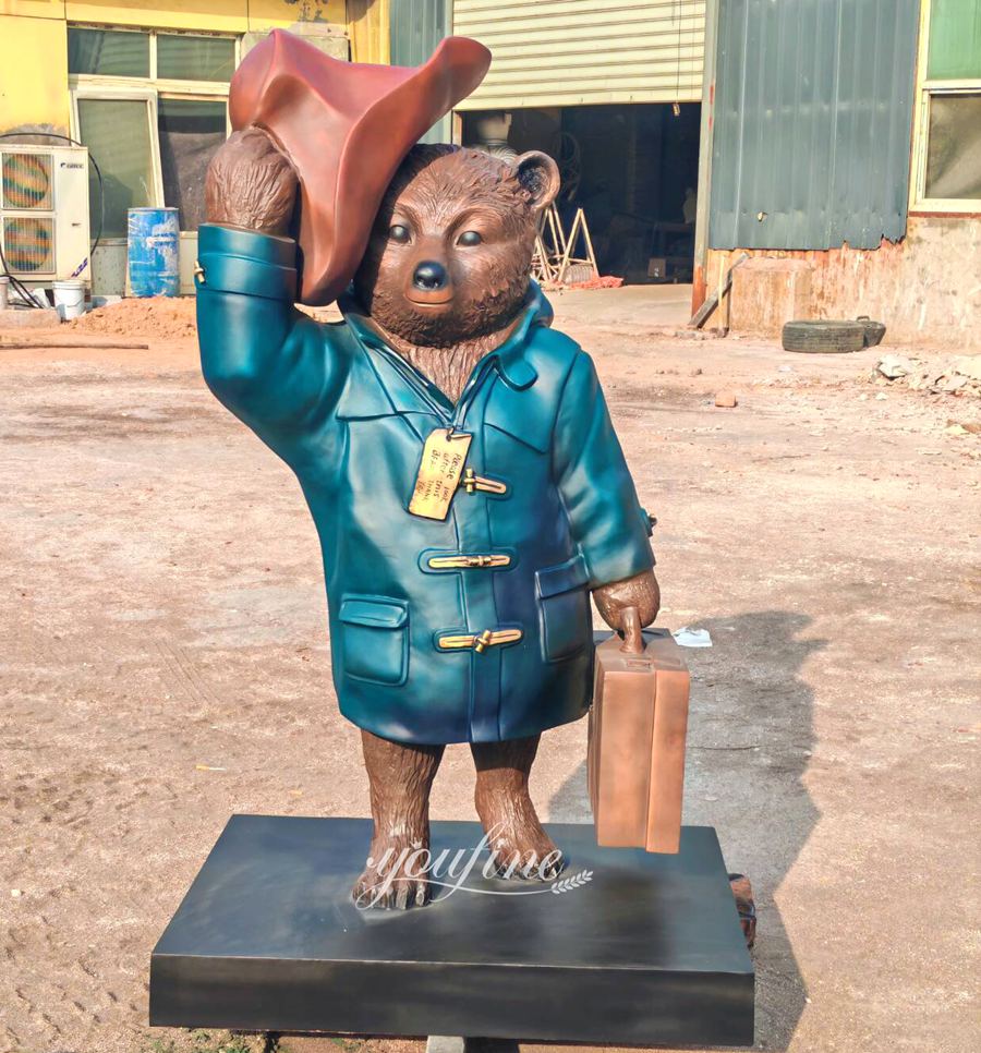 Paddington Bear carrying a suitcase