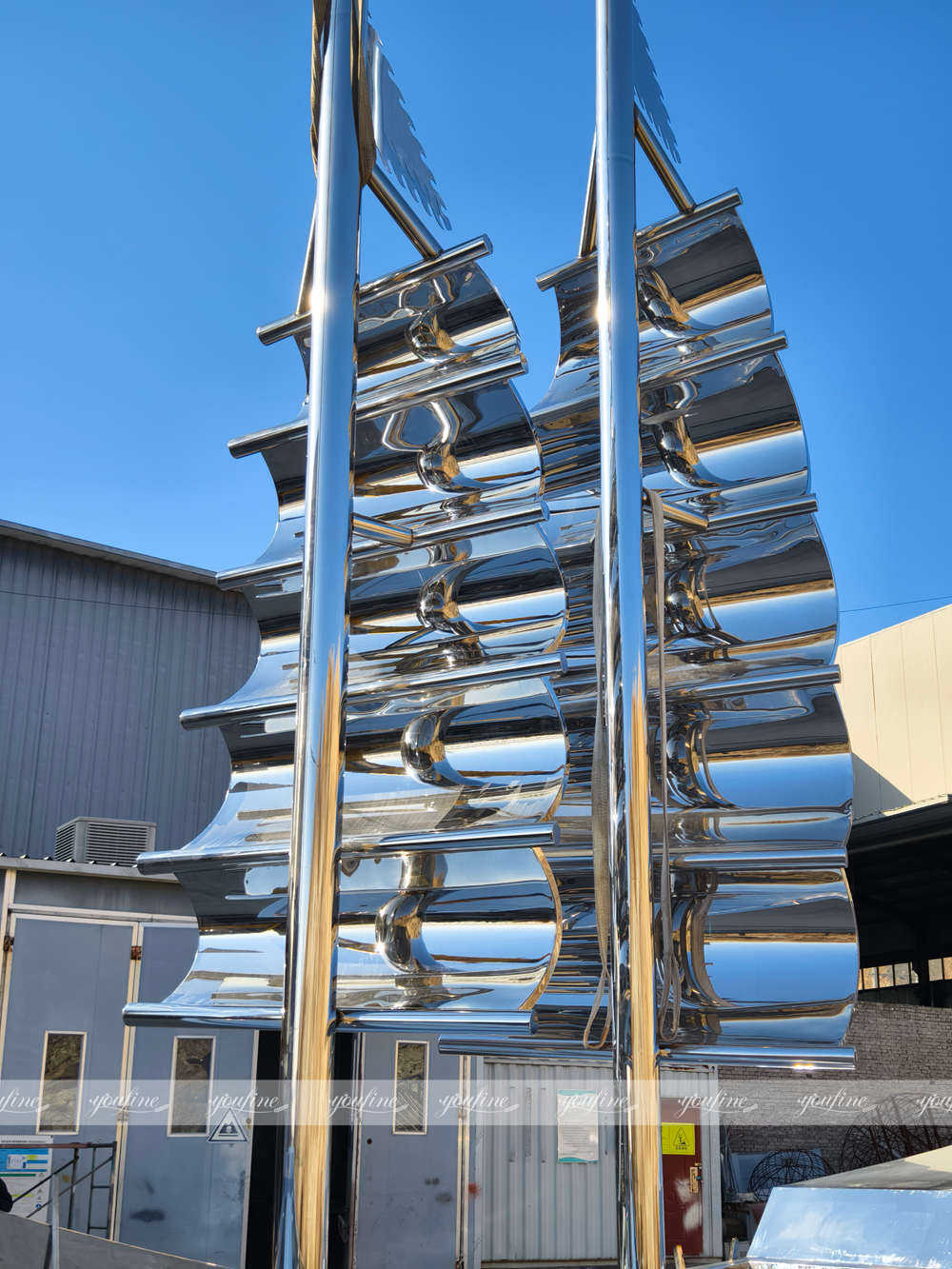 intricate details of mirror polished stainless steel boat sculpture