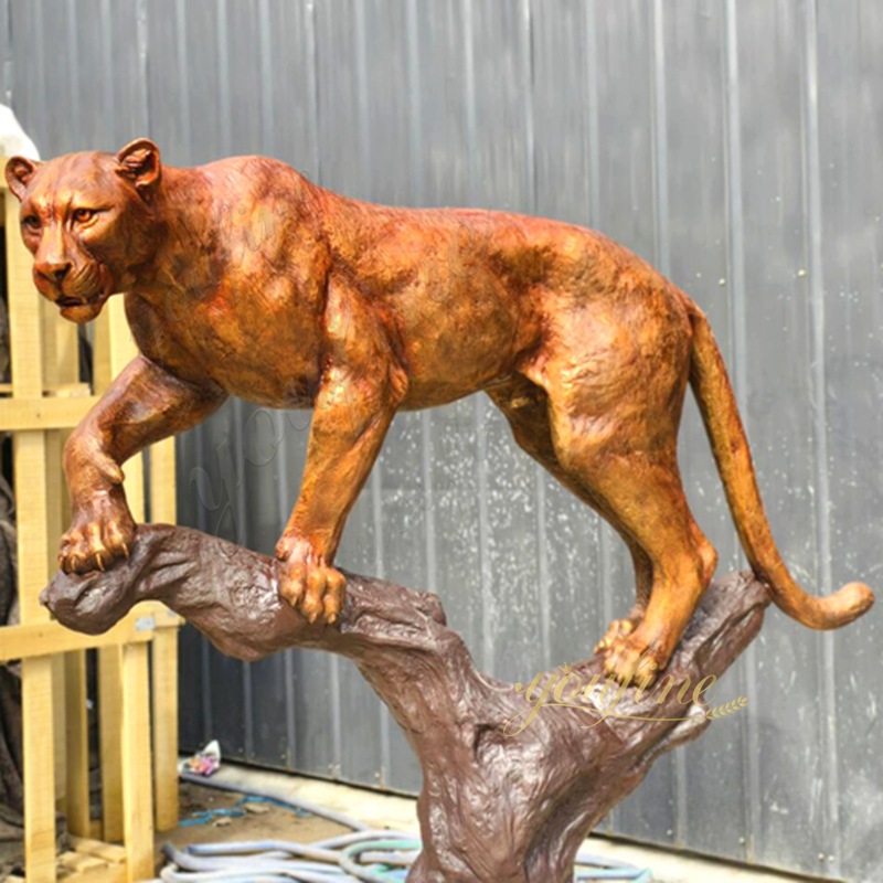 bronze mountain lion climbing up branch