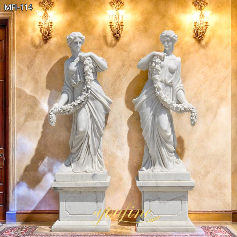 white marble female statue holding flower