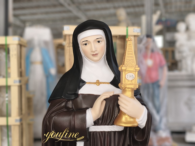 Painted marble Saint Clare of Assisi statue detail