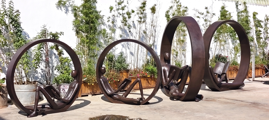 Abstract Man Reading Sculpture Inside the Ring