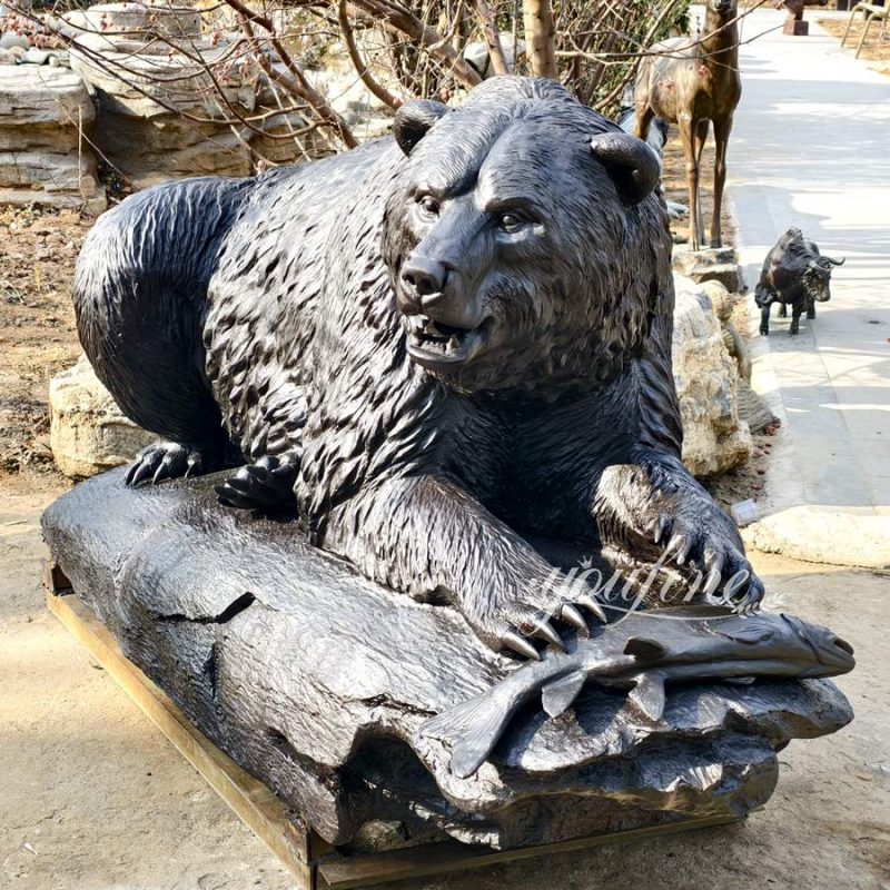 Grizzly Bear with a fish sculpture