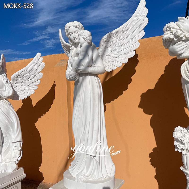angel holding baby statue