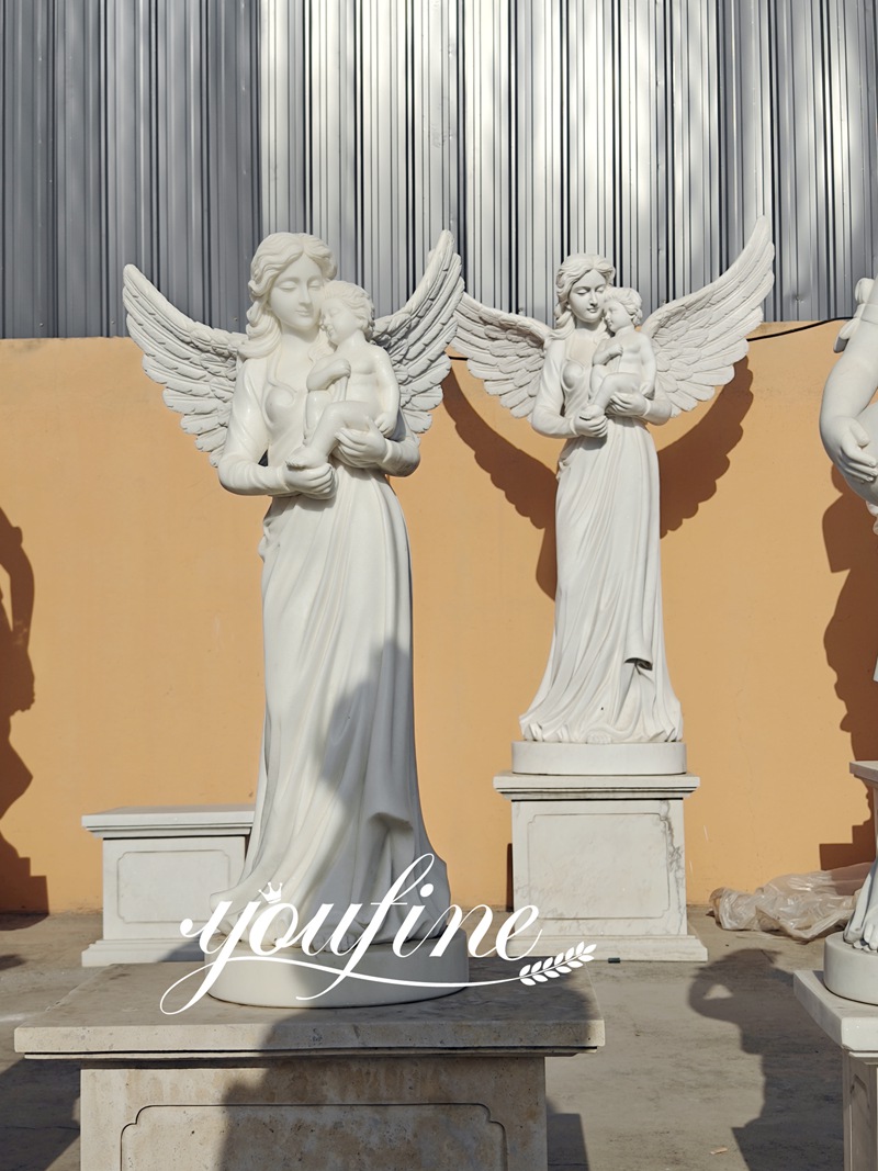angel holding baby statues