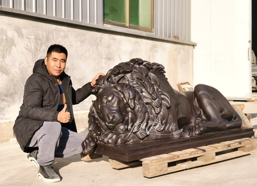 Bronze sleeping lion sculpture