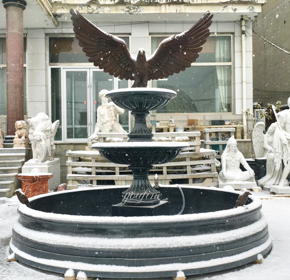 outdoor large garden black fountain in snow