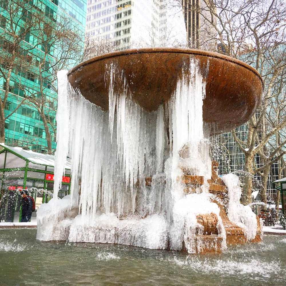 outdoor large garden marble fountain in snow