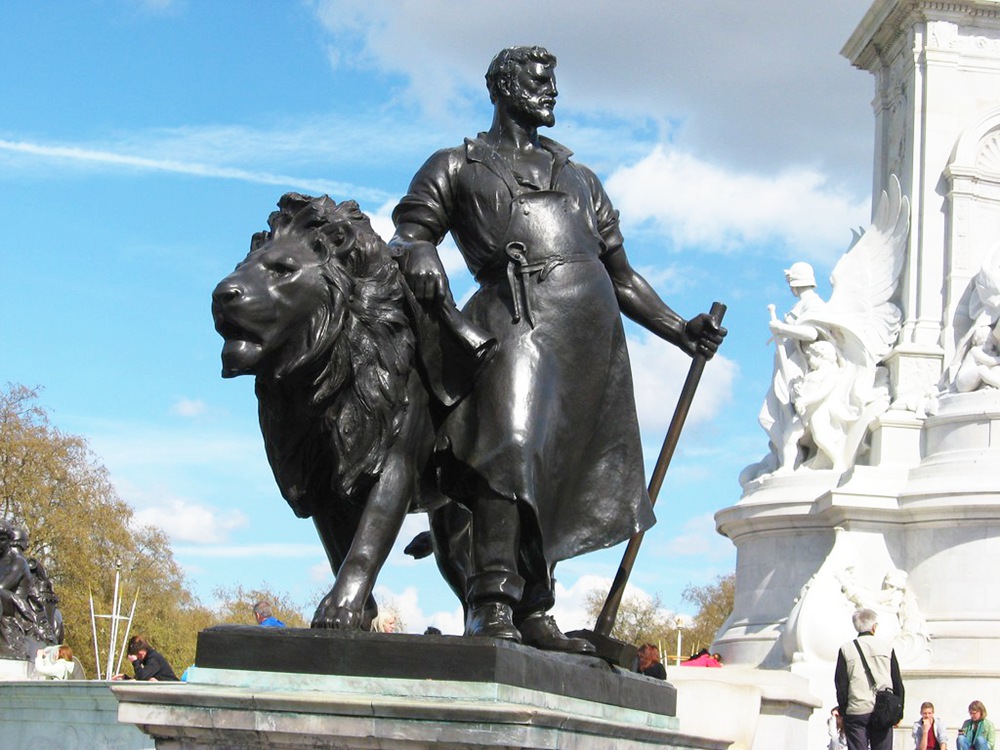 Bronze Statues of Lions and Blacksmiths on the Base of the Victoria Memorial in Front of Buckingham Palace, London