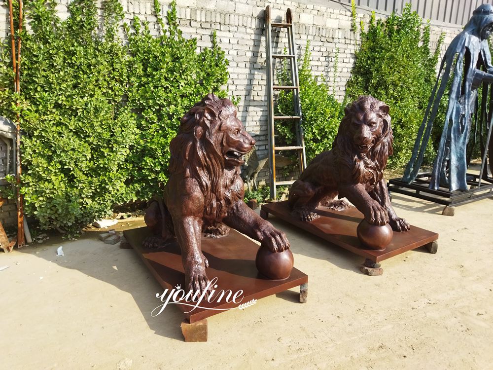bronze lion with ball statue