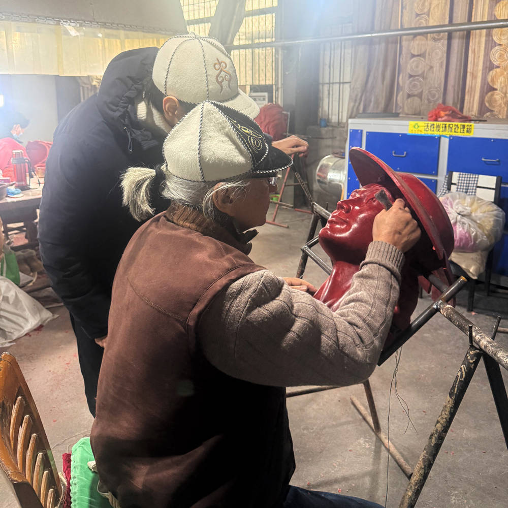 Professional artists are refining the wax shell of the sculpture