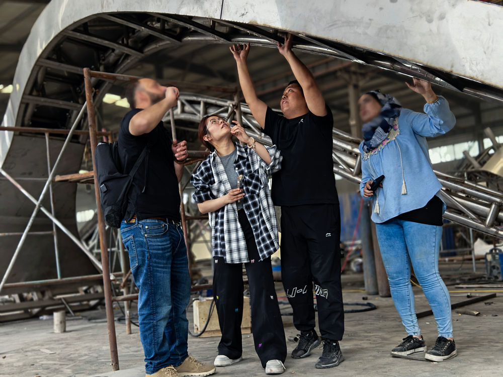 Client visit during production: inspecting the sculpture's sturdy internal structure.
