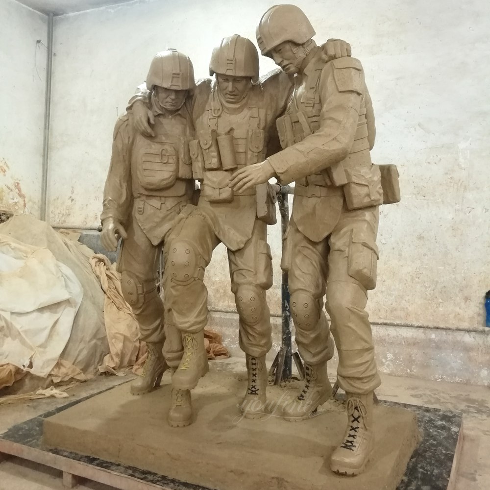 Vergleich der Tonform mit der fertigen Bronzeskulptur der Militärdenkmalstatue „No One Left Behind“, die drei einander stützende Soldaten zeigt