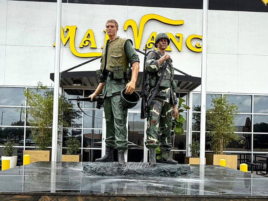 bronze military memorial sculpture with American and South Vietnamese flags in Vietnam