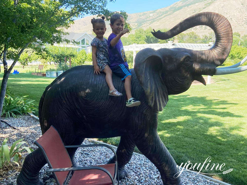 Client's children playing beside the bronze elephant sculpture in their garden