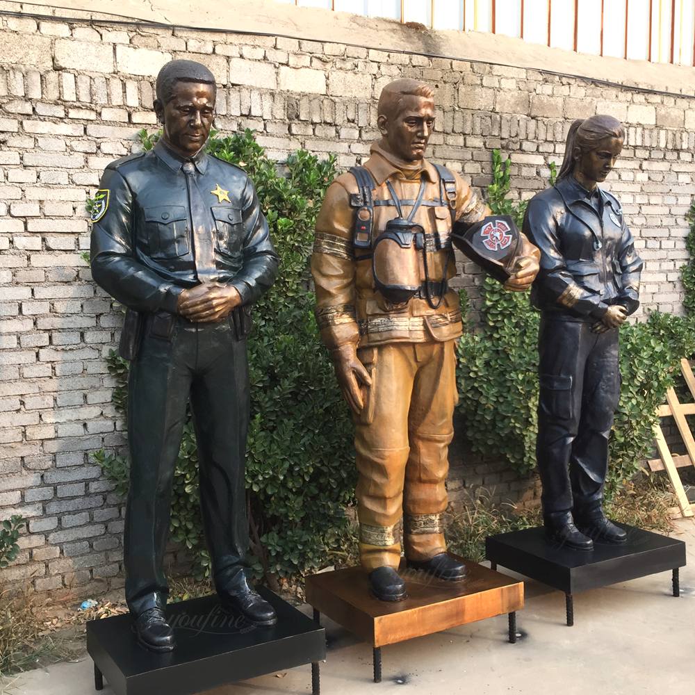 Finished bronze firefighter, police officer, and paramedic statues painted in authentic uniform colors for Los Angeles First Responders memorial