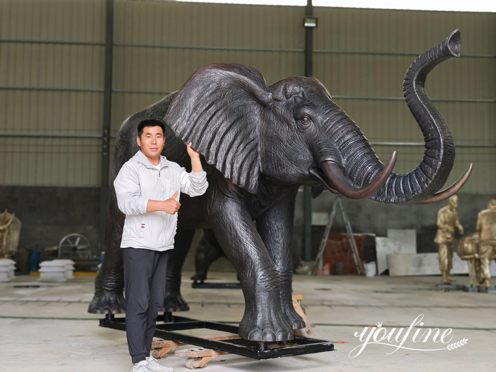 Quality inspection of a finished bronze elephant sculpture at the YouFine factory