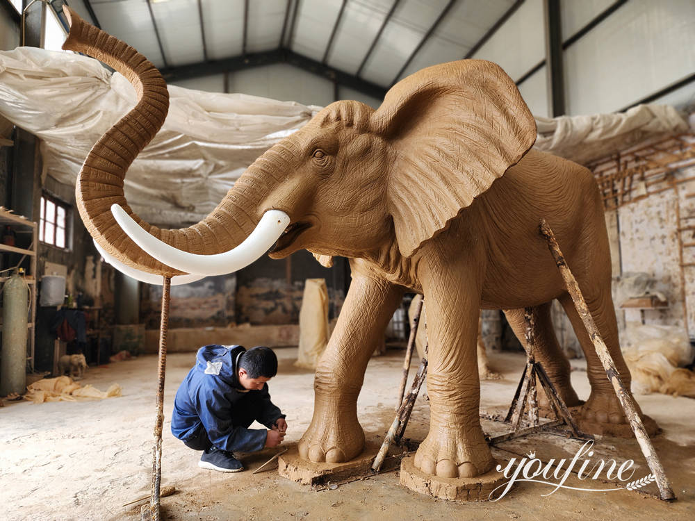 YouFine artist shaping the clay model for a custom bronze elephant sculpture